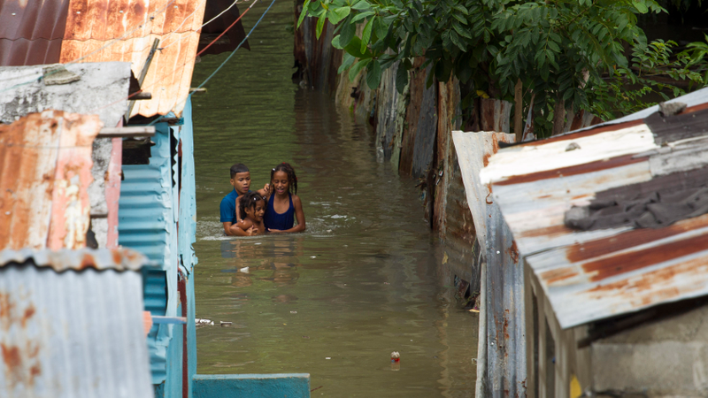 Picture taken in the flooded neighbourhood of La Puya, in Santo Domingo on October 4, 2016 after the passage of Hurricane Matthew through Hispaniola — the island that the Dominican Republic shares with Haiti. Matthew, a Category Four hurricane, slammed into the Dominican Republic and Haiti Tuesday, triggering major floods and forcing thousands to flee the path of the storm that has claimed at least three lives in each country.(Image: Getty)